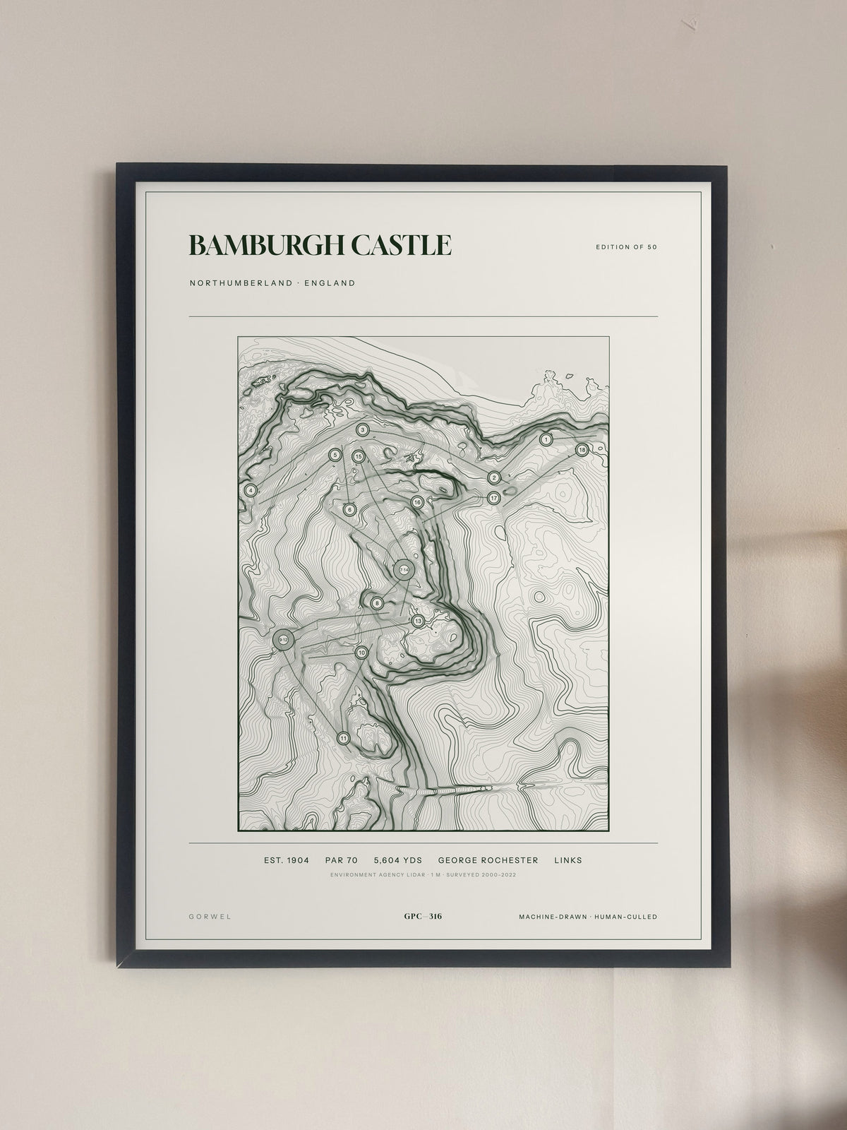 Bamburgh Castle, Northumberland print, framed, on a wall